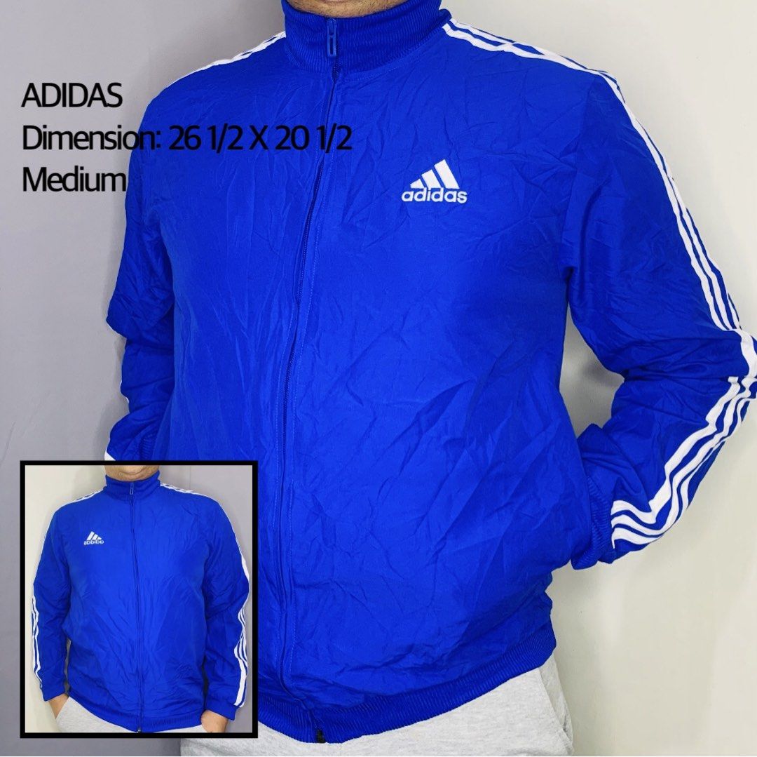 Adidas Blue Track Jacket Medium (Category: Coats, Jackets and Outerwear) located in Taguig. Submitted by citytrendsph (Listing ID 1469665517, Image 1). Description: - Brand: Adidas - Color: Bright blue with white accents - Size: Medium - Measurements: 26 1/2 x 20 1/2 inches - Features: Full zip, stand-up collar, ribbed cuffs and hem - Details: Classic white three stripes on sleeves and embroidered logo on chest - Condition: Excellent, ready to we