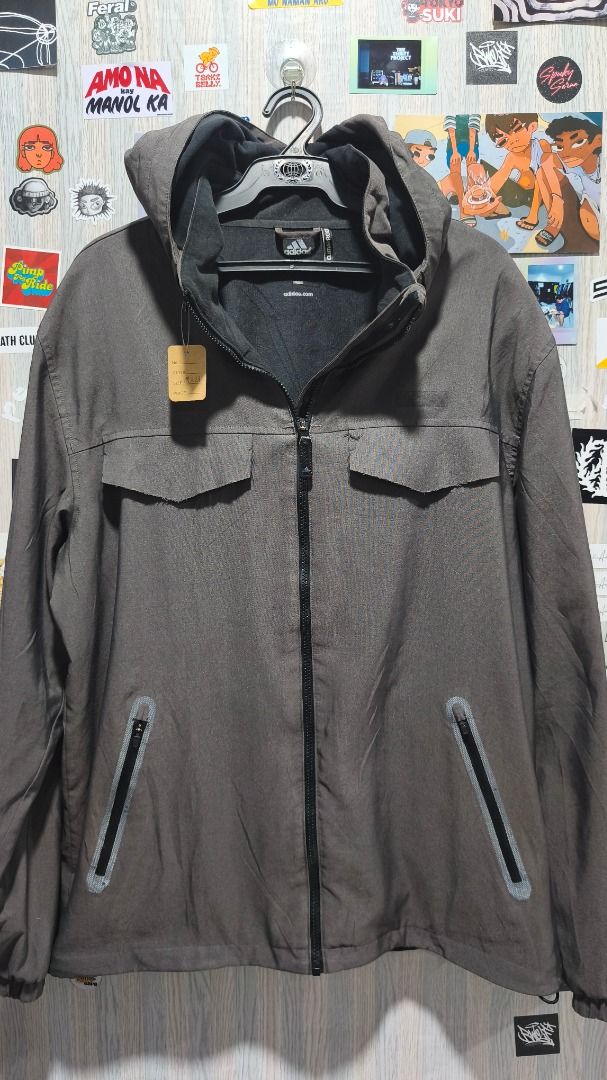 Adidas Climaproof Grey Hooded Jacket (Category: Coats, Jackets and Outerwear) located in Davao. Submitted by thethriftproject082 (Listing ID 1469748801, Image 2). Description: - Brand: Adidas - Color: Grey - Condition: Brand new with tags attached - Technology: Climacool for dryness and comfort - Closure: Full front zip - Storage: 2 chest flap pockets and 2 lower zippered pockets - Fit & Adjustability: Adjustable cuffs and drawcord hem - Extra Fe