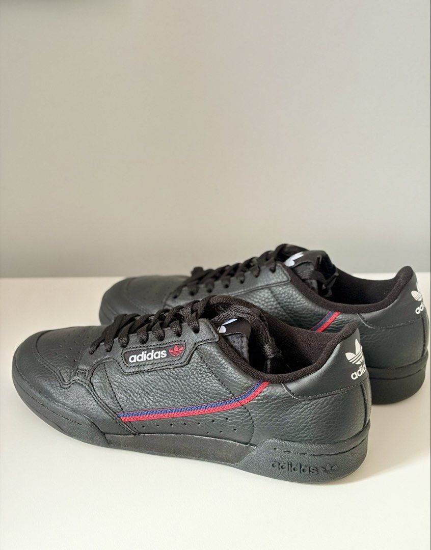 Adidas Continental 80 Black Sneakers (Category: Sneakers) located in Mandaluyong City. Submitted by luckyphoenix_88ff96 (Listing ID 1469648087, Image 2). Description: - Brand: Adidas Continental 80 - Colorway: Black tumbled leather with red and blue stripe details - Details: White branding on tongue, side, and heel with matching black laces and rubber cupsole - Condition: Very clean uppers and nicely maintained soles - Style: Great everyday casua