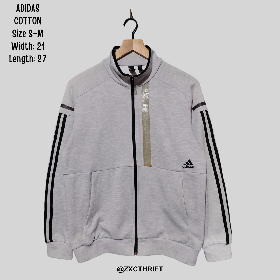 Adidas Cotton Track Jacket Grey Size S-M (Category: Coats, Jackets and Outerwear) located in Caloocan City. Submitted by zxcthrift (Listing ID 1469641752, Image 1). Description: - Brand: Adidas - Style: Cotton zip-up jacket with stand-up collar - Color: Light grey with black 3-stripes down the arms - Features: Full front zip, 2 front pockets, ribbed cuffs/hem, and embroidered logo - Size: Fits S to M - Measurements: Width 21 inches, Length 27 inc