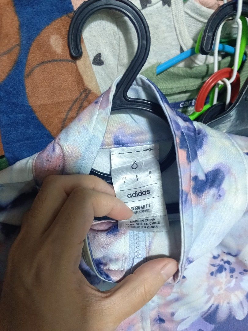 Adidas Floral Track Jacket Size 6 (Category: Coats, Jackets and Outerwear) located in General Trias. Submitted by felgemdedi33956 (Listing ID 1469617695, Image 2). Description: - Brand: Adidas - Style: Zip-up track jacket with mock neck - Design: Pastel floral tie-dye (purple, blue, pink, white) - Fit: Regular fit - Size: Tagged Size 6 - Origin: Made in China - Condition: Excellent / Great for casual wear.