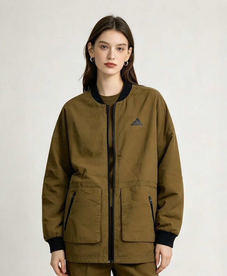 Adidas Olive Green Bomber Jacket with Zip Pockets (Category: Coats, Jackets and Outerwear) located in Narra. Submitted by rhyanguan63087 (Listing ID 1469617691, Image 1). Description: - Brand: Adidas - Style: Bomber jacket - Color: Olive green with black ribbed collar, cuffs, and hem - Closure: Full zip front - Pockets: Two secure front zip pockets - Details: Black mesh interior lining and "SPORT IS WHO I AM WHAT I AM" printed placket - Size: 160