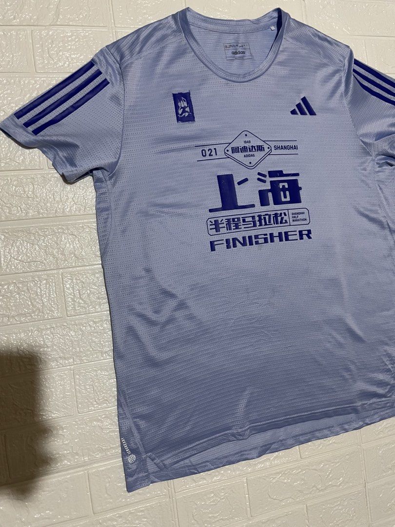 Adidas Shanghai Half Marathon Finisher Tee (Category: Activewear) located in Marilao. Submitted by clear_out_closet (Listing ID 1469582944, Image 2). Description: Item Details: 👇 • Brand: Adidas Performance • Event: Official 2023 Shanghai Half Marathon “Finisher” Gear • Style Code: IJ7311 • Color: Periwinkle / Light Lavender Blue with Royal Blue Graphics • Retail Value: Official Race Participant Exclusive (Equivalent Adidas AEROREADY running top