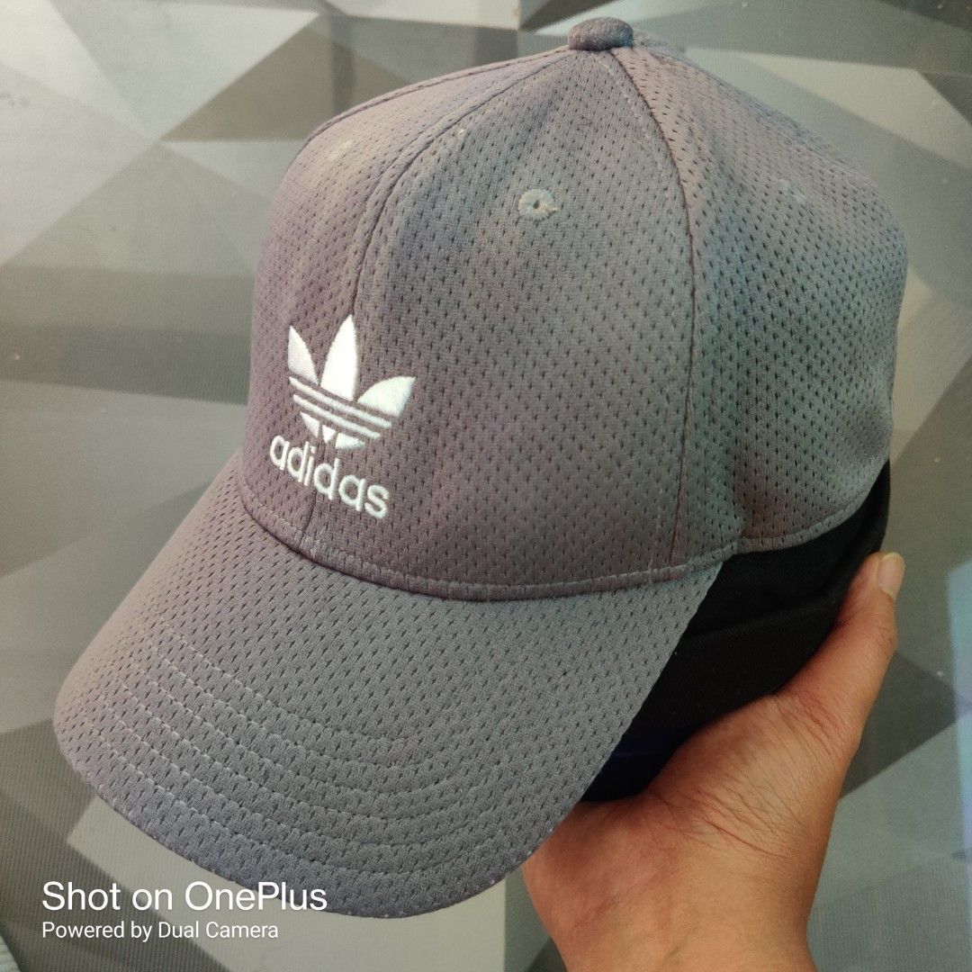 Adidas trefoil logo baseball cap (Category: Caps & Hats) located in Baguio. Submitted by ferns_garage.0924 (Listing ID 1469622252, Image 2). Description: The image shows a grey mesh Adidas Originals baseball cap featuring an embroidered white Trefoil logo on the front. • Brand: Adidas Originals • Design: All-over breathable mesh texture with a curved brim • Logo: White embroidered Adidas Trefoil logo and wordmark • Fit: Stretch-fit / flexible siz