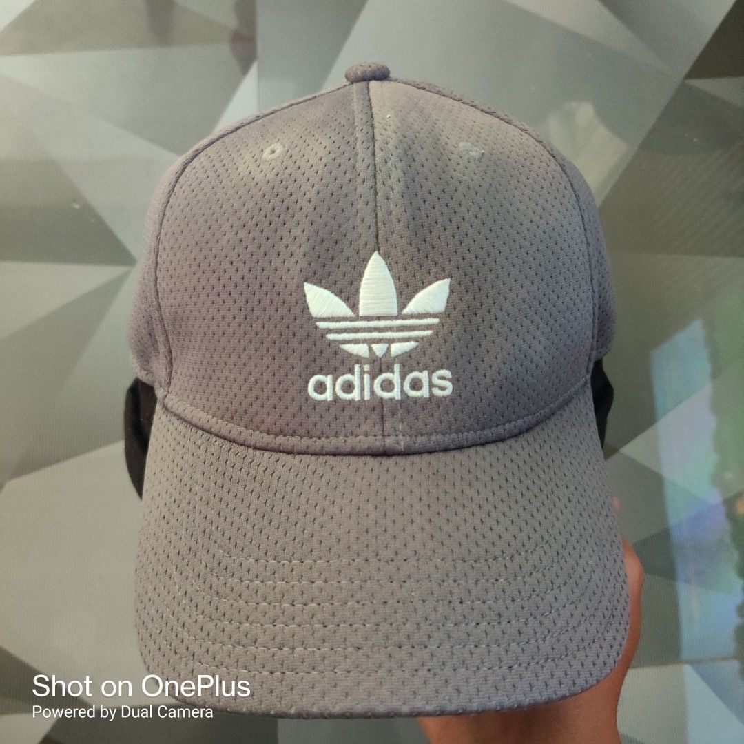 Adidas trefoil logo baseball cap (Category: Caps & Hats) located in Baguio. Submitted by ferns_garage.0924 (Listing ID 1469622252, Image 1). Description: The image shows a grey mesh Adidas Originals baseball cap featuring an embroidered white Trefoil logo on the front. • Brand: Adidas Originals • Design: All-over breathable mesh texture with a curved brim • Logo: White embroidered Adidas Trefoil logo and wordmark • Fit: Stretch-fit / flexible siz