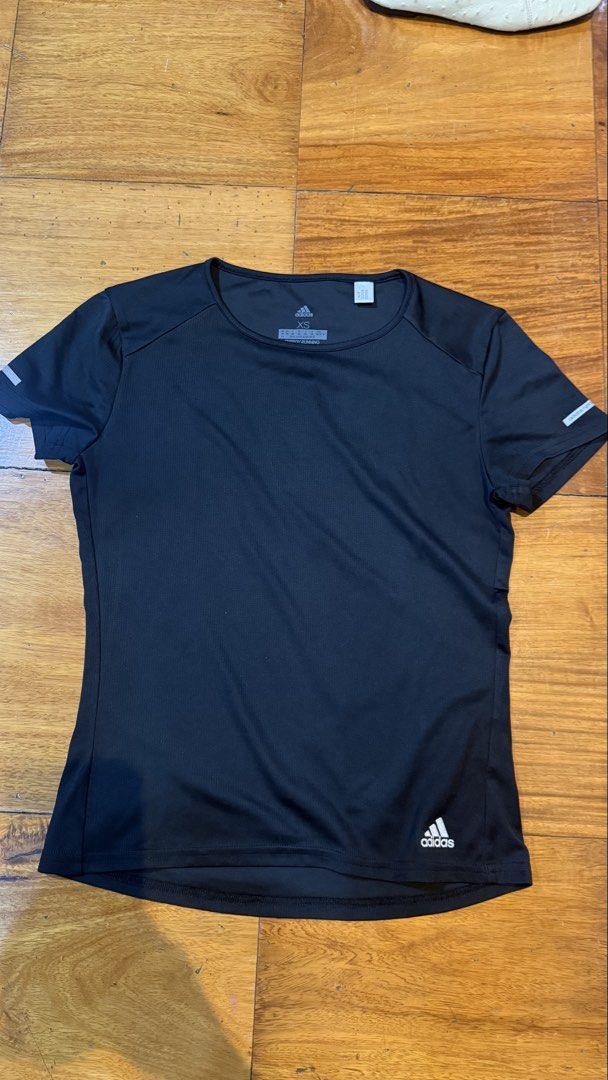 Adidas Women's Running Tshirt (Category: Activewear) located in Makati City. Submitted by thevault88 (Listing ID 1469694396, Image 2). Description: - Brand: Adidas - Style: Running top / Athletic wear - Color: Black - Size: Women's Extra Small (XS) - Features: Breathable fabric, reflective sleeve details, small hem logo, crew neckline, short sleeves - Condition: Clean inside and out, no flaws - Ideal for: Gym sessions, running, and workouts.