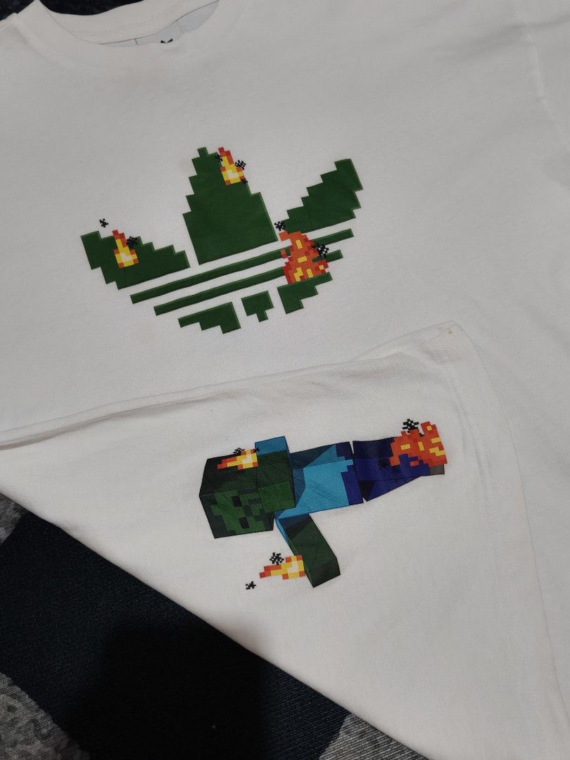 Adidas x Minecraft (Category: Tshirts & Polo Shirts ) located in Andop. Submitted by kyutoryuu (Listing ID 1469582020, Image 2). Description: Adidas x Minecraft •Dimes: 20x25 •Condition: Excellent •CR: 9.5/10 •Issue: need rewash.