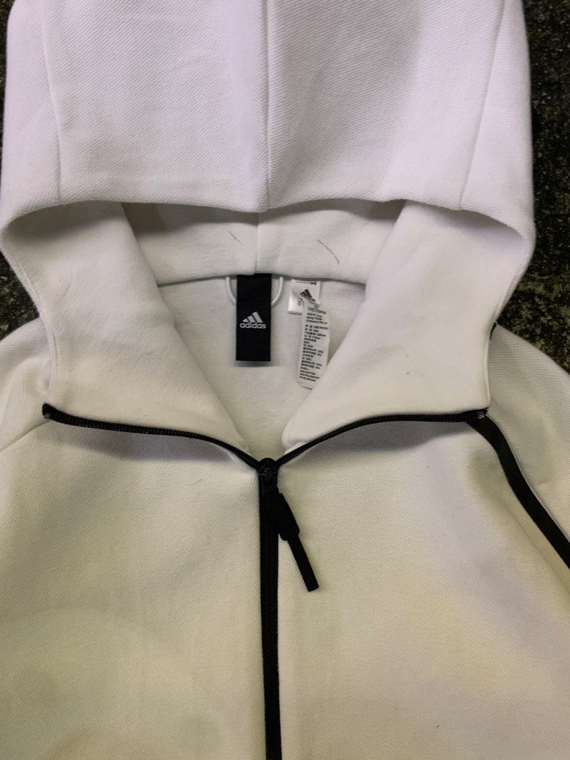Adidas Z.N.E. White Full Zip Hoodie Jacket (Category: Coats, Jackets and Outerwear) located in Manila. Submitted by thrift2mnla (Listing ID 1469680686, Image 3). Description: - Authentic Adidas Z.N.E. full zip hoodie in clean white - Stylish black contrast piping along the zipper and shoulders - Adidas logo printed on the left sleeve - Two secure front pockets with zipper closures - Interior neck tape with motivational quotes - Breathable mesh pa