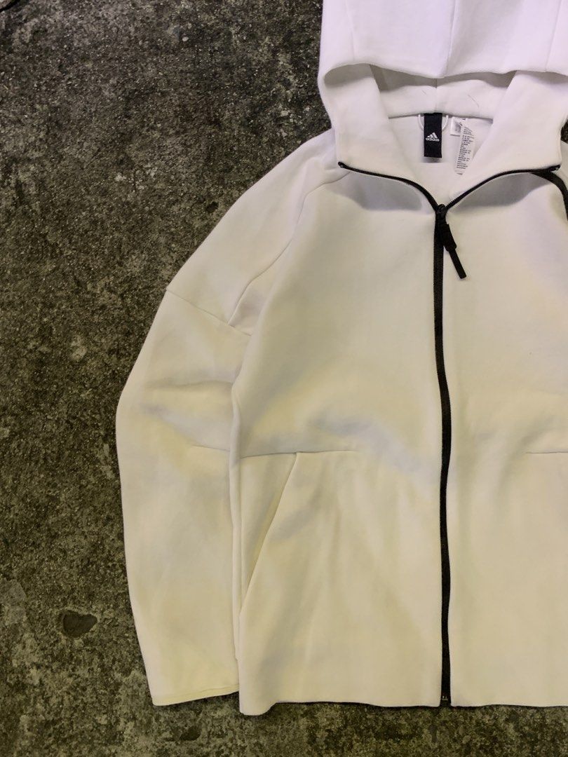 Adidas Z.N.E. White Full Zip Hoodie Jacket (Category: Coats, Jackets and Outerwear) located in Manila. Submitted by thrift2mnla (Listing ID 1469680686, Image 2). Description: - Authentic Adidas Z.N.E. full zip hoodie in clean white - Stylish black contrast piping along the zipper and shoulders - Adidas logo printed on the left sleeve - Two secure front pockets with zipper closures - Interior neck tape with motivational quotes - Breathable mesh pa