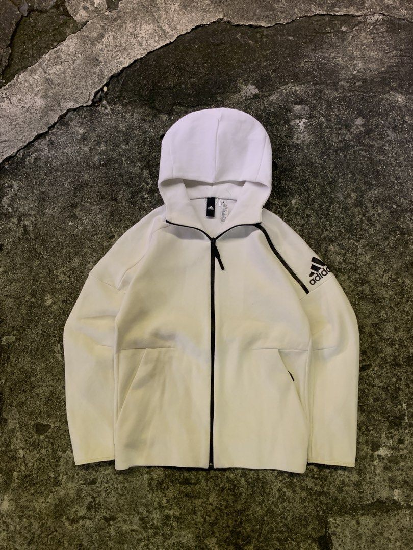 Adidas Z.N.E. White Full Zip Hoodie Jacket (Category: Coats, Jackets and Outerwear) located in Manila. Submitted by thrift2mnla (Listing ID 1469680686, Image 1). Description: - Authentic Adidas Z.N.E. full zip hoodie in clean white - Stylish black contrast piping along the zipper and shoulders - Adidas logo printed on the left sleeve - Two secure front pockets with zipper closures - Interior neck tape with motivational quotes - Breathable mesh pa