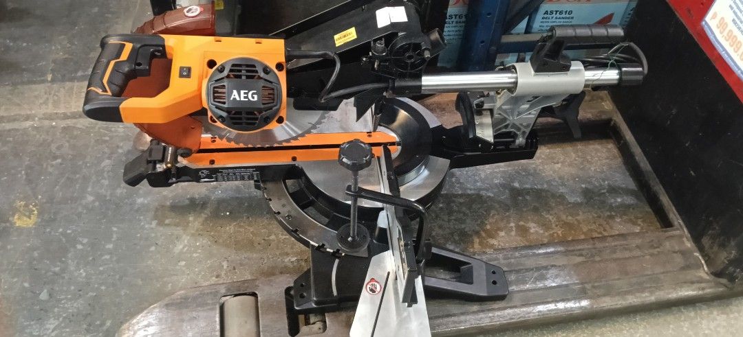 AEG Sliding Miter Saw Power Tool Orange Black (Category: Construction Tools & Equipment) located in Manila. Submitted by jesicahmrsantarosa (Listing ID 1469592920, Image 3). Description: - Brand/Model: AEG Sliding Miter Saw - Color: Orange and Black - Type: Heavy-duty power tool for woodworking and DIY projects - Features: Adjustable angle settings, clear blade guard for safety - Build: Sturdy metal base with slide rails - Condition: Great for wo