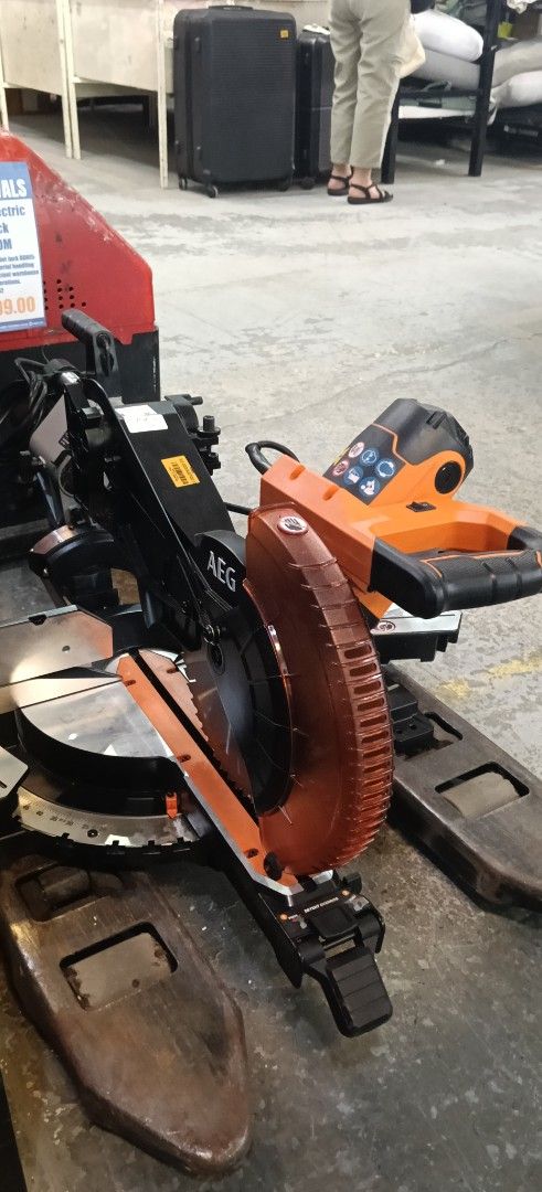 AEG Sliding Miter Saw Power Tool Orange Black (Category: Construction Tools & Equipment) located in Manila. Submitted by jesicahmrsantarosa (Listing ID 1469592920, Image 1). Description: - Brand/Model: AEG Sliding Miter Saw - Color: Orange and Black - Type: Heavy-duty power tool for woodworking and DIY projects - Features: Adjustable angle settings, clear blade guard for safety - Build: Sturdy metal base with slide rails - Condition: Great for wo