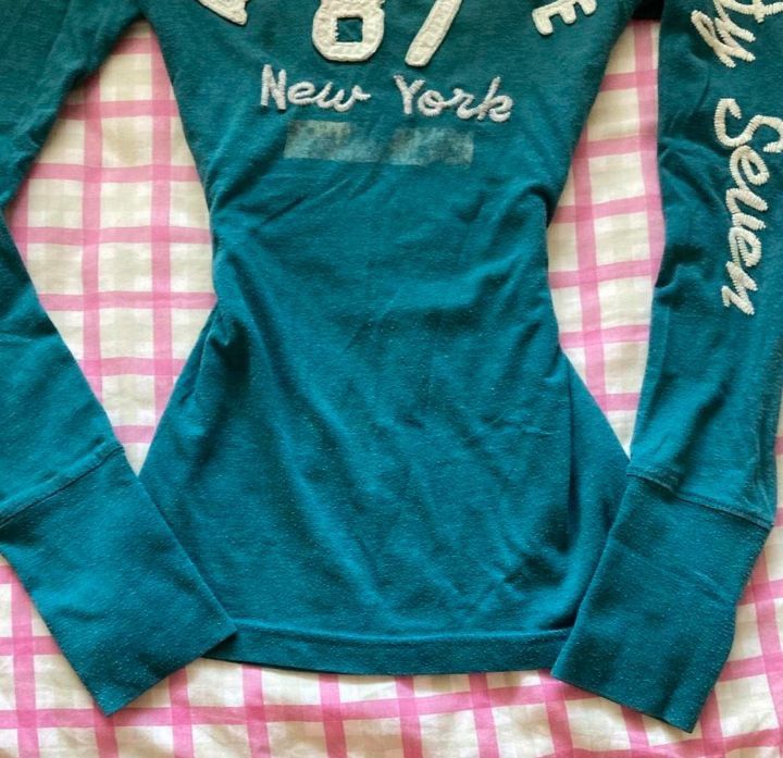 Aeropostale Eighty Seven New York Long Sleeve Tee (Category: Longsleeves) located in Manila. Submitted by y2k_thrift_ (Listing ID 1469714713, Image 3). Description: - Brand: Aeropostale - Color: Teal Green - Size: L/G - Material: 60% Cotton, 40% Polyester - Design: Big embroidered chest logo with '87 New York' lettering and 'Eighty Seven' down the left sleeve - Details: Crew neck style with ribbed cuffs - Origin: Made in Indonesia.
