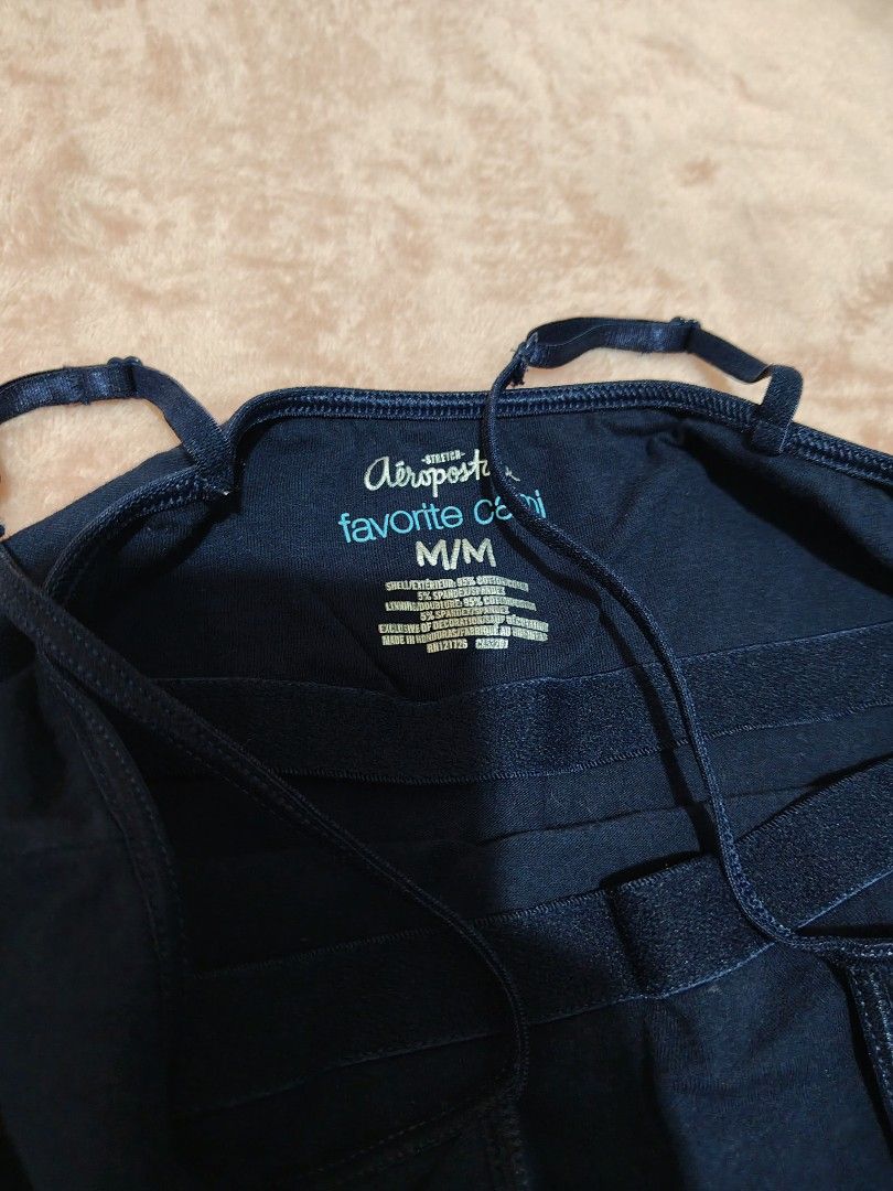 Aeropostale Favorite Cami Navy (Category: Sleeveless) located in Villasis. Submitted by trip_thrift15 (Listing ID 1469697725, Image 3). Description: - Brand: Aeropostale - Style: Favorite Cami - Color: Navy Blue - Size: Medium (M) - Material: 95% Cotton, 5% Spandex (Stretchable & comfortable) - Features: Adjustable spaghetti straps, embroidered Aero logo near bottom hem - Care: Machine washable - Flaw: Minor tiny speck mark on the fabric flaws-do
