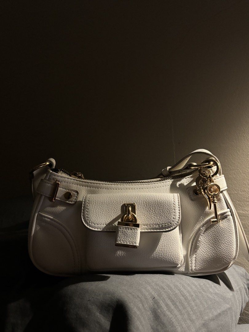 Aldo White Bag (Category: Shoulder Bags) located in Manila. Submitted by luckiachai (Listing ID 1469688698, Image 3). Description: Elegant and stylish ALDO white shoulder bag featuring a beautiful textured finish, luxurious gold-tone hardware, and a charming front flap pocket. It comes with a top zipper closure, a detachable-looking gold key charm, and an adjustable strap for a chic and versatile look. Perfect for casual outings, dates, parties, 