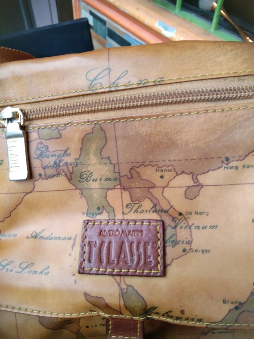 Alviero Martini (Category: Cross-body Bags) located in Manila. Submitted by mysticshark-0a05e9 (Listing ID 1469757017, Image 2). Description: - Authentic Alviero Martini 1ᴬ Classe crossbody bag - Signature geographical map print with premium tan leather trim - Adjustable leather strap for a customized fit - Secure front flap closure with magnetic snap - Exterior zip pocket on the flap for easy access - Spacious interior with fabric lining and an 