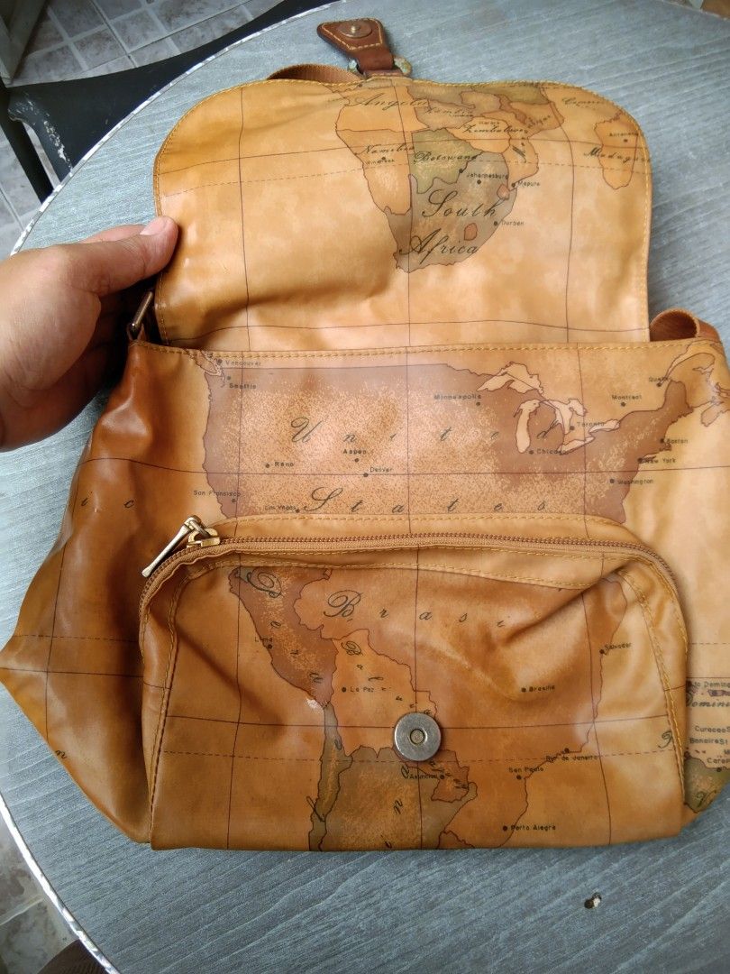 Alviero Martini (Category: Cross-body Bags) located in Manila. Submitted by mysticshark-0a05e9 (Listing ID 1469757017, Image 3). Description: - Authentic Alviero Martini 1ᴬ Classe crossbody bag - Signature geographical map print with premium tan leather trim - Adjustable leather strap for a customized fit - Secure front flap closure with magnetic snap - Exterior zip pocket on the flap for easy access - Spacious interior with fabric lining and an 