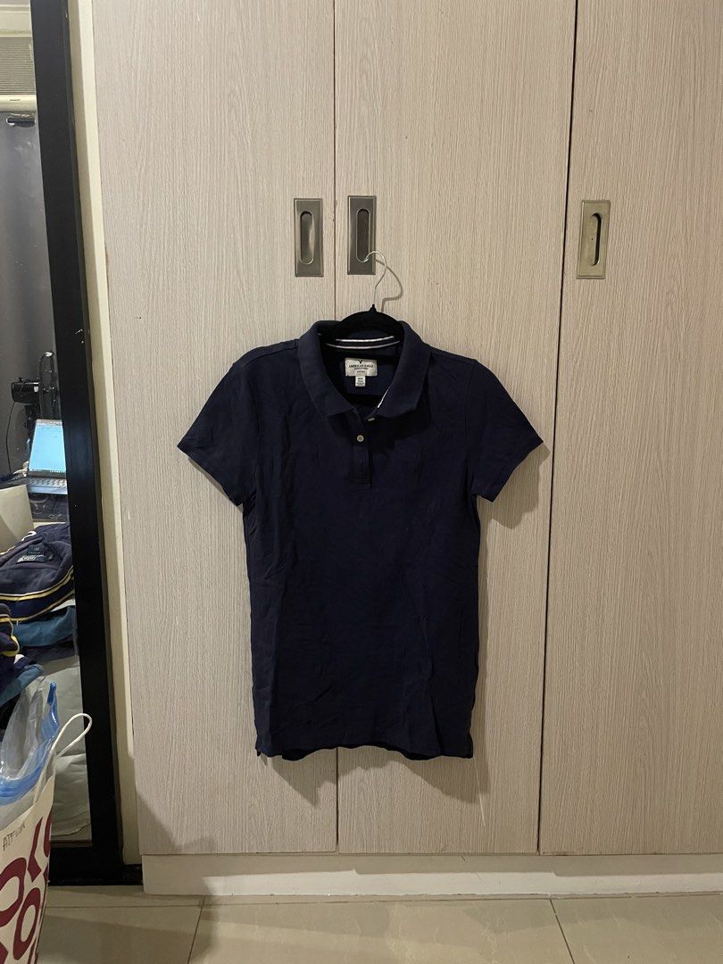 American Eagle Navy Blue Polo Shirt (Category: Shirts) located in Marikina City. Submitted by _dailydoseofclothing (Listing ID 1469710376, Image 1). Description: - Brand: American Eagle - Color: Navy Blue - Style: Short sleeve polo shirt with standard collar and button placket - Fit: Comfortable for casual daily wear - Versatility: Classic solid piece, easy to match with jeans or shorts.