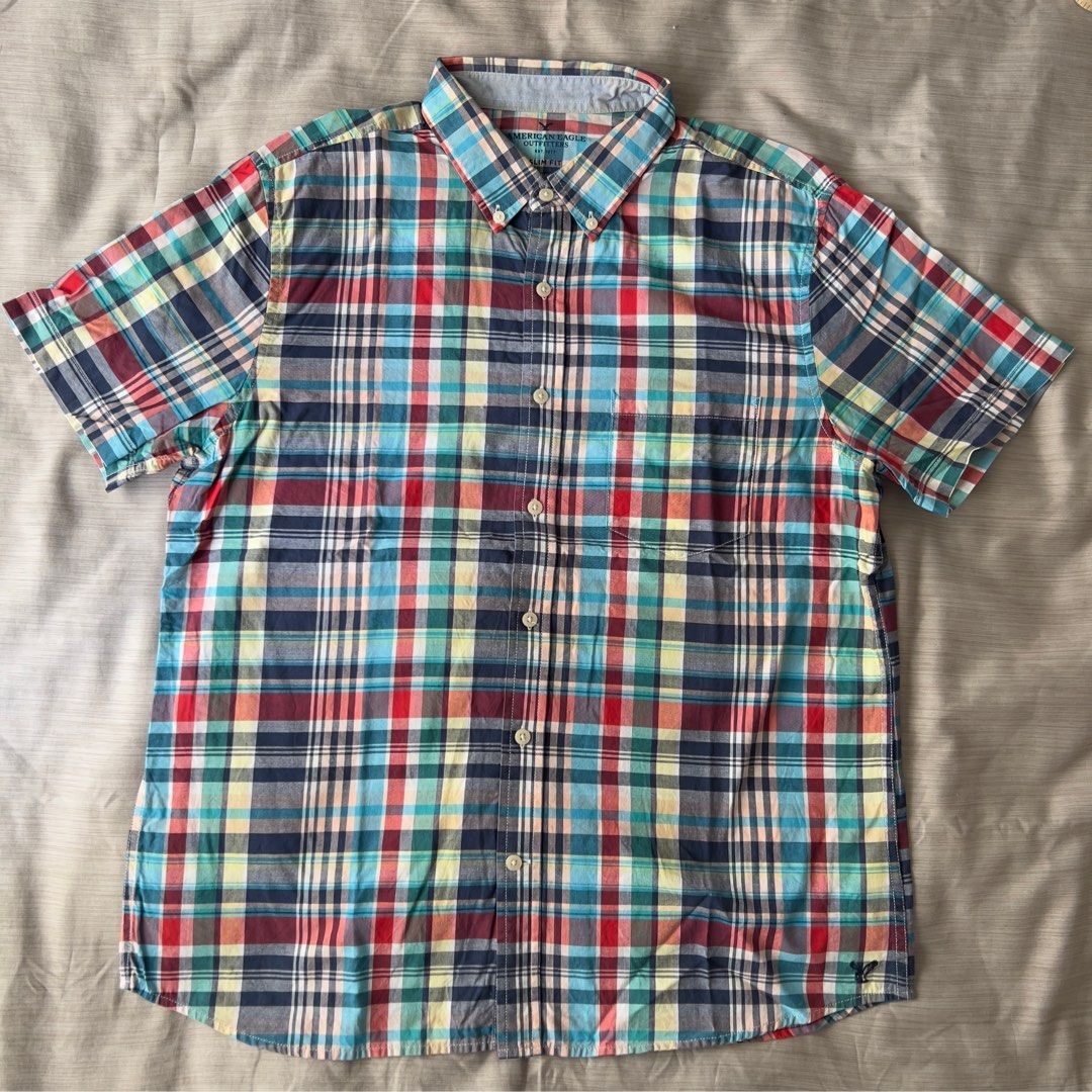 American Eagle Outfitters Plaid Slim Fit (Category: Tshirts & Polo Shirts ) located in Pasig City. Submitted by jenscloset86 (Listing ID 1469635048, Image 1). Description: Brand: American Eagle Outfitters Size: Large • No damage. • Flaw: light yellow stain in the collar due to gold stainless necklace color transfer. • good condition. • slim fit design Dimension: Length: 27.5” Chest: 21” Shoulder: 17” Sleeve: 9”.