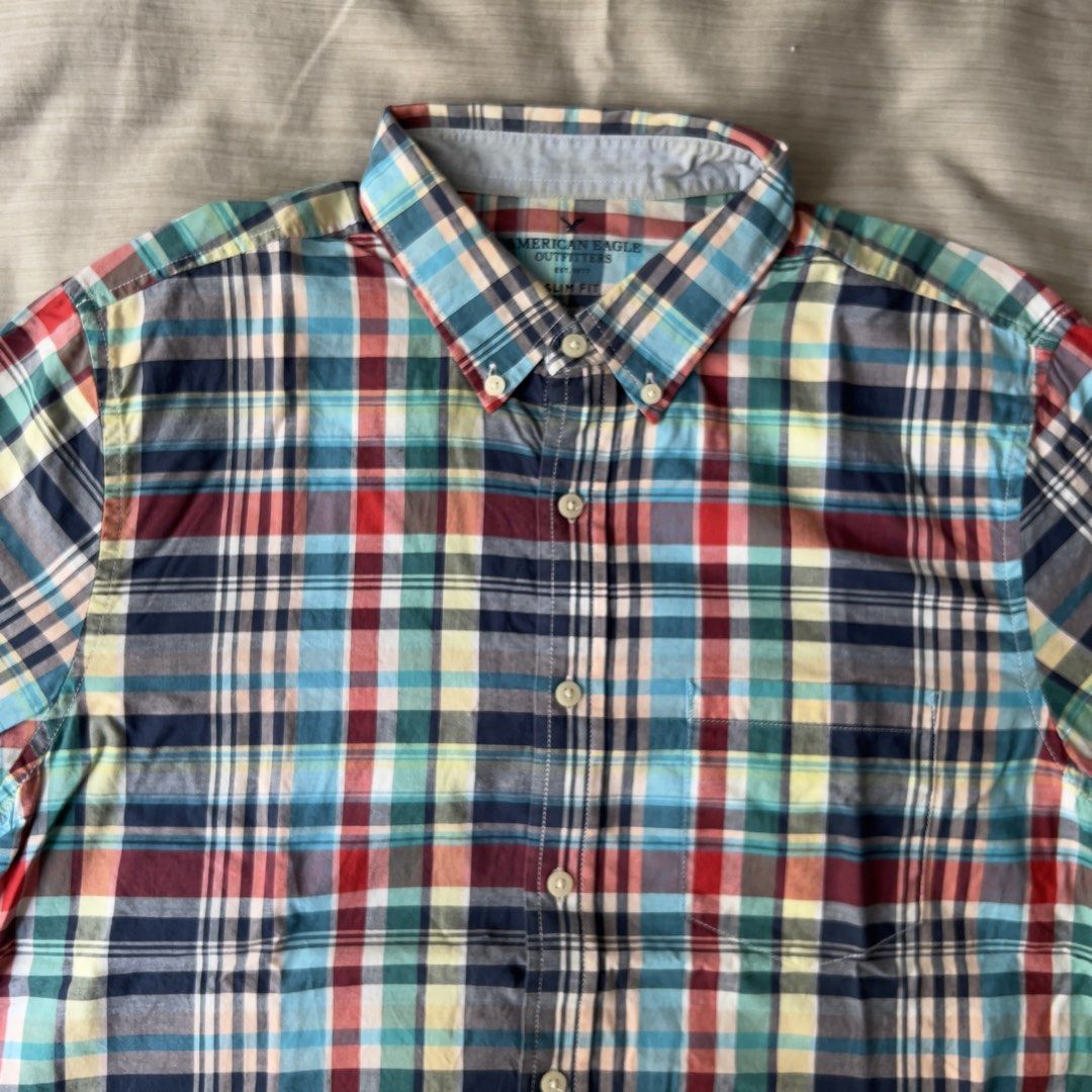 American Eagle Outfitters Plaid Slim Fit (Category: Tshirts & Polo Shirts ) located in Pasig City. Submitted by jenscloset86 (Listing ID 1469635048, Image 3). Description: Brand: American Eagle Outfitters Size: Large • No damage. • Flaw: light yellow stain in the collar due to gold stainless necklace color transfer. • good condition. • slim fit design Dimension: Length: 27.5” Chest: 21” Shoulder: 17” Sleeve: 9”.