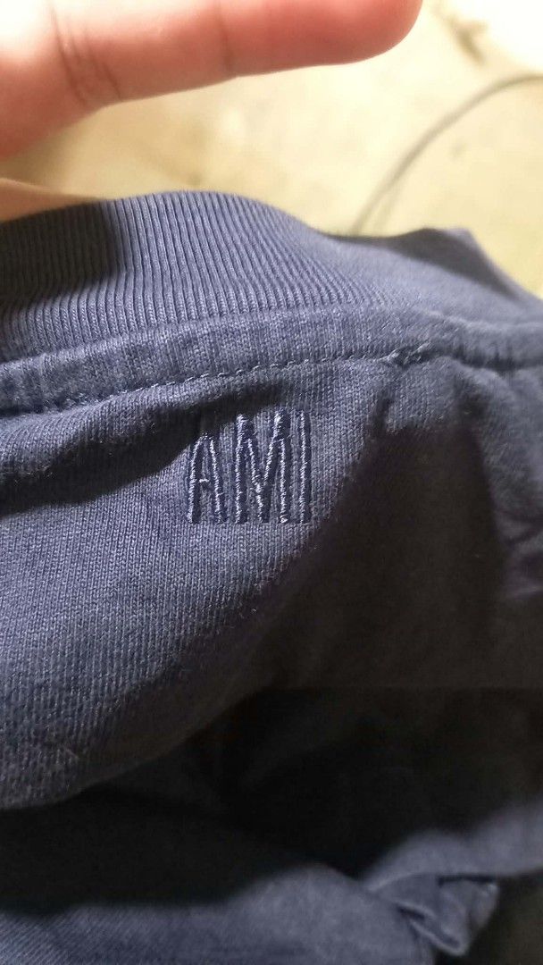 Ami Paris Black T-Shirt Size S (Category: Activewear) located in Manila. Submitted by pablo.405 (Listing ID 1469689971, Image 3). Description: - Brand: AMI Paris - Color: Dark Navy Blue - Size: Small (S) - Material: 100% Organic Cotton (Made in Portugal) - Design: White embroidered bubble lettering on the chest, ribbed crewneck with inner AMI embroidery - Inclusions: Brand tags and QR code wash label intact - Guaranteed authentic.