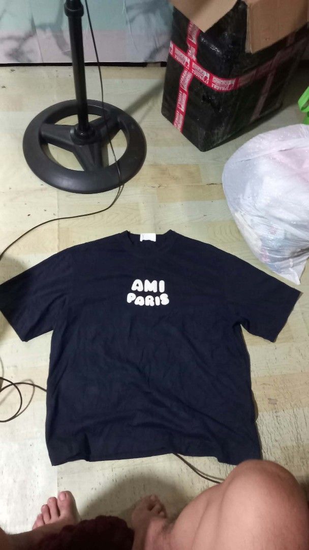Ami Paris Black T-Shirt Size S (Category: Activewear) located in Manila. Submitted by pablo.405 (Listing ID 1469689971, Image 1). Description: - Brand: AMI Paris - Color: Dark Navy Blue - Size: Small (S) - Material: 100% Organic Cotton (Made in Portugal) - Design: White embroidered bubble lettering on the chest, ribbed crewneck with inner AMI embroidery - Inclusions: Brand tags and QR code wash label intact - Guaranteed authentic.