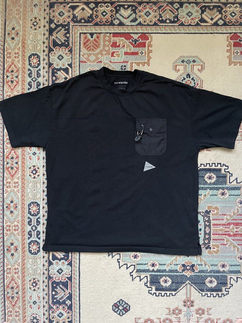 And Wander Black Pocket T-Shirt (Category: Tshirts & Polo Shirts ) located in Pasig City. Submitted by erzvgo (Listing ID 1469638367, Image 1). Description: And Wander black tshirt Size large, boxy fit Contrast chest pocket with button flap closure. Mini carabiner attached to the pocket. Reflective triangle logo printed lower down on the front. Relaxed fit, drop shoulders. Buyer handles delivery from Makati.