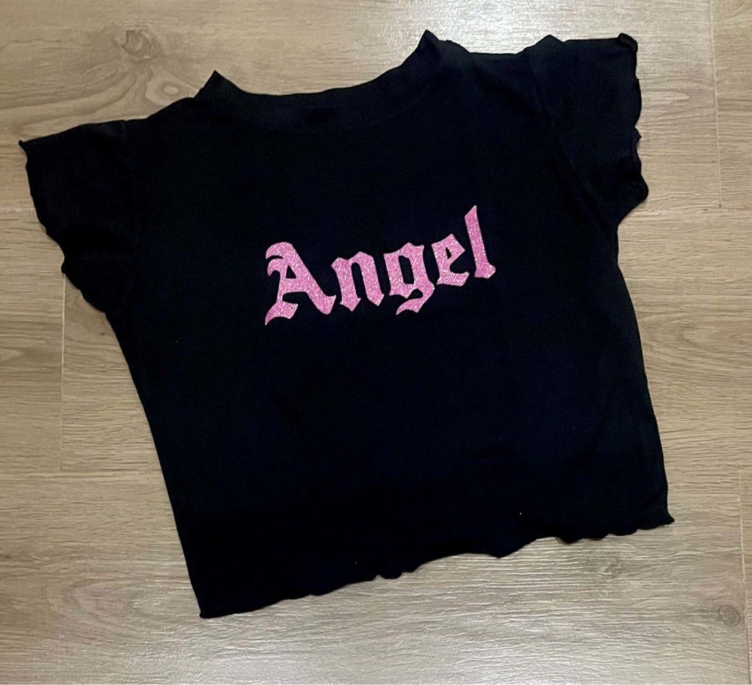 Angel Black Crop Top 💗 (Category: Blouses) located in Bulacan. Submitted by ladyjagged (Listing ID 1469717941, Image 1). Description: * Size: XS–Small * Color: Black * Style: Cropped baby tee * Design: Pink glitter print with back details * Short sleeves with cute wavy hems.