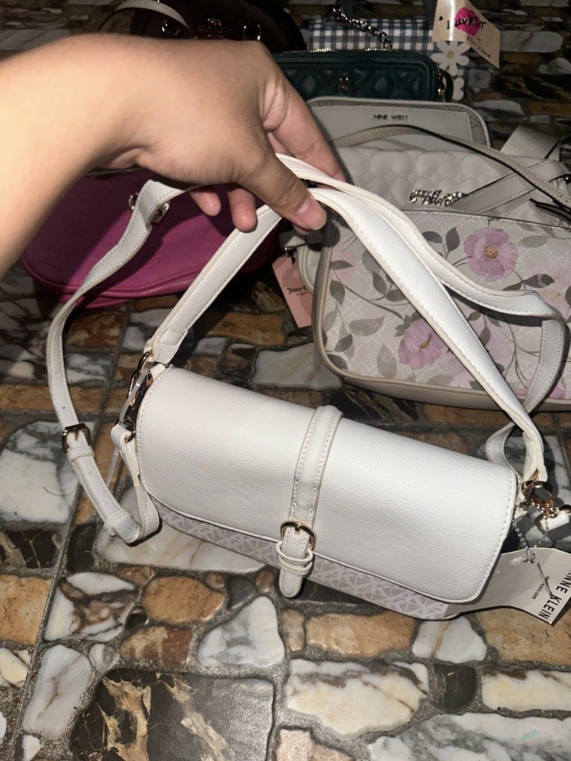 Anne Klein White Crossbody Bag with Monogram Pattern (Category: Cross-body Bags) located in Bugallon. Submitted by lavenderlane (Listing ID 1469669272, Image 3). Description: - Brand: Anne Klein - Color: White and beige with gold-toned hardware - Design: Monogram print on the lower front with flap top and buckle accent - Strap: Adjustable shoulder strap - Interior: Fabric lined with a zippered pocket and brand patch - Condition: Brand new with or