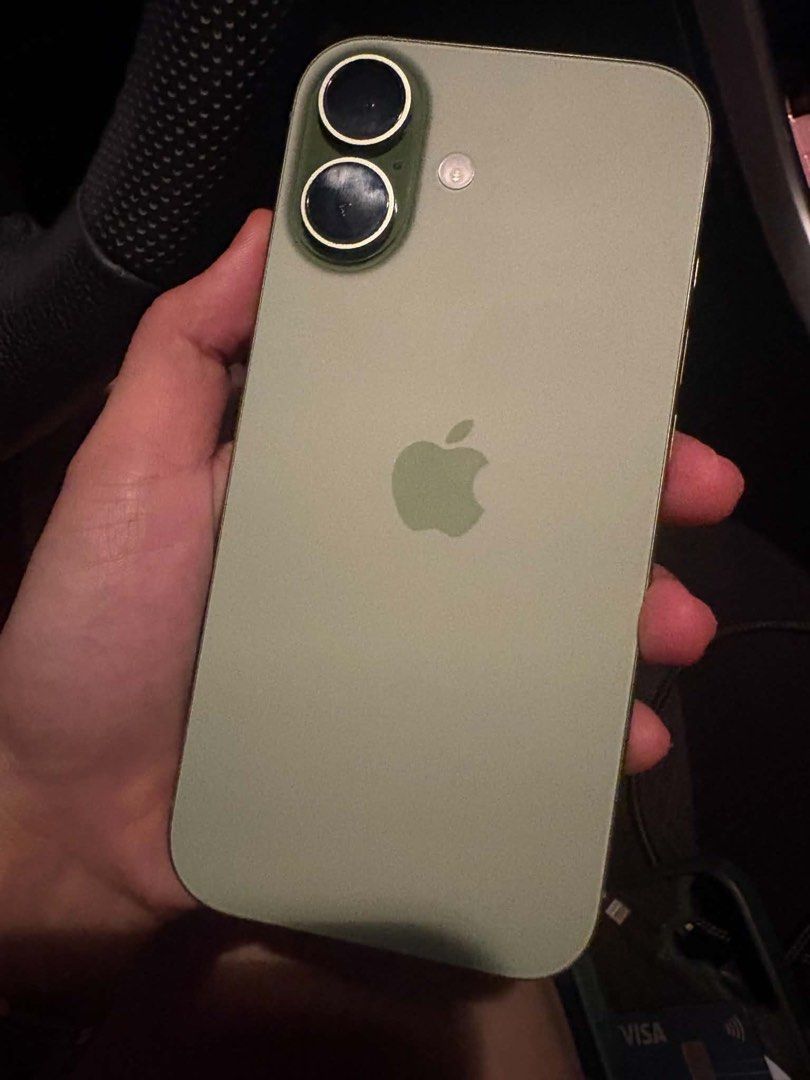 Apple iPhone Green (Category: iPhone 17 Series) located in Quezon City. Submitted by maemae482580600 (Listing ID 1469703534, Image 2). Description: Green iPhone model. Dual cameras on the back with metal lens protector rings. Original box and Power Mac Center paper bag included. Battery health at 93 percent with 321 cycle counts. Clean screen and back glass..