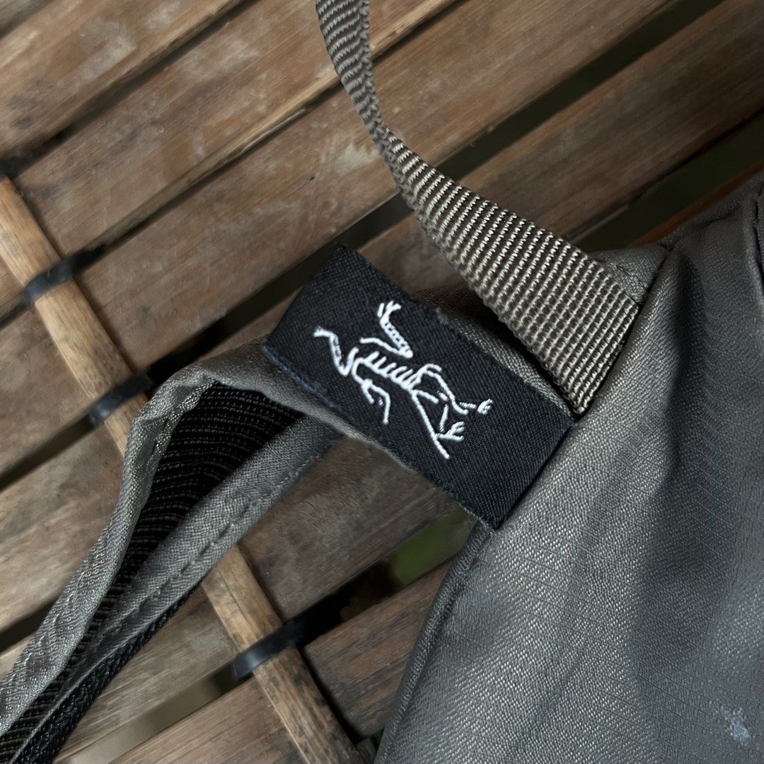 Arc'teryx Heliad 15L Backpack Grey (Category: Backpacks) located in M'Lang. Submitted by alexpabillo0324 (Listing ID 1469699453, Image 3). Description: - Brand: Arc'teryx - Model: Heliad 15L Backpack - Color: Grey - Condition: Excellent / Pre-owned - Design: Lightweight, minimalist daypack with top grab handle and adjustable shoulder straps - Storage: Secure zippered main compartment and front pocket with branded pulls - Authenticity: Internal ta