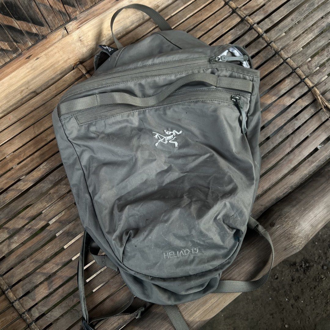 Arc'teryx Heliad 15L Backpack Grey (Category: Backpacks) located in M'Lang. Submitted by alexpabillo0324 (Listing ID 1469699453, Image 1). Description: - Brand: Arc'teryx - Model: Heliad 15L Backpack - Color: Grey - Condition: Excellent / Pre-owned - Design: Lightweight, minimalist daypack with top grab handle and adjustable shoulder straps - Storage: Secure zippered main compartment and front pocket with branded pulls - Authenticity: Internal ta