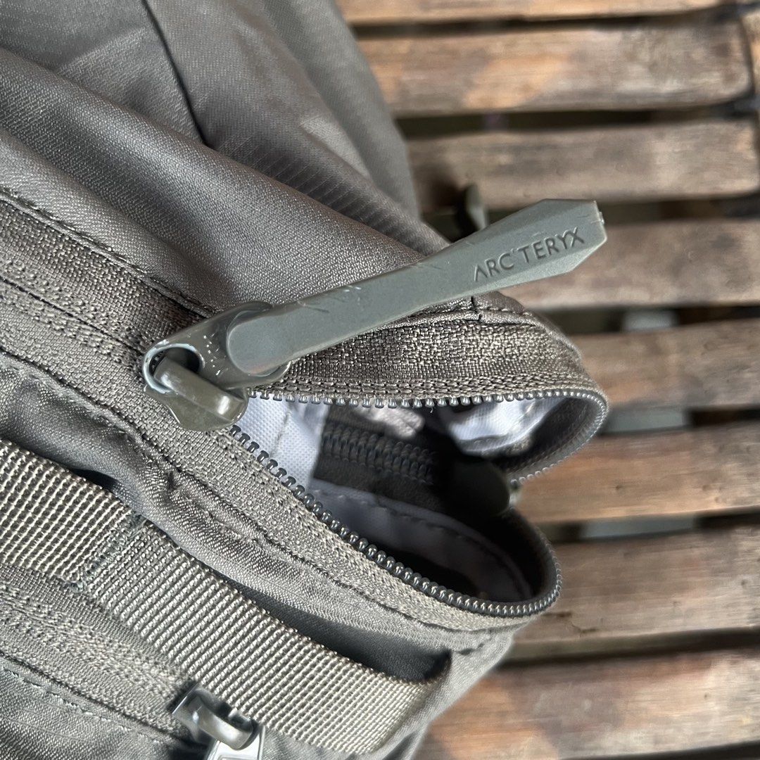 Arc'teryx Heliad 15L Backpack Grey (Category: Backpacks) located in M'Lang. Submitted by alexpabillo0324 (Listing ID 1469699453, Image 2). Description: - Brand: Arc'teryx - Model: Heliad 15L Backpack - Color: Grey - Condition: Excellent / Pre-owned - Design: Lightweight, minimalist daypack with top grab handle and adjustable shoulder straps - Storage: Secure zippered main compartment and front pocket with branded pulls - Authenticity: Internal ta