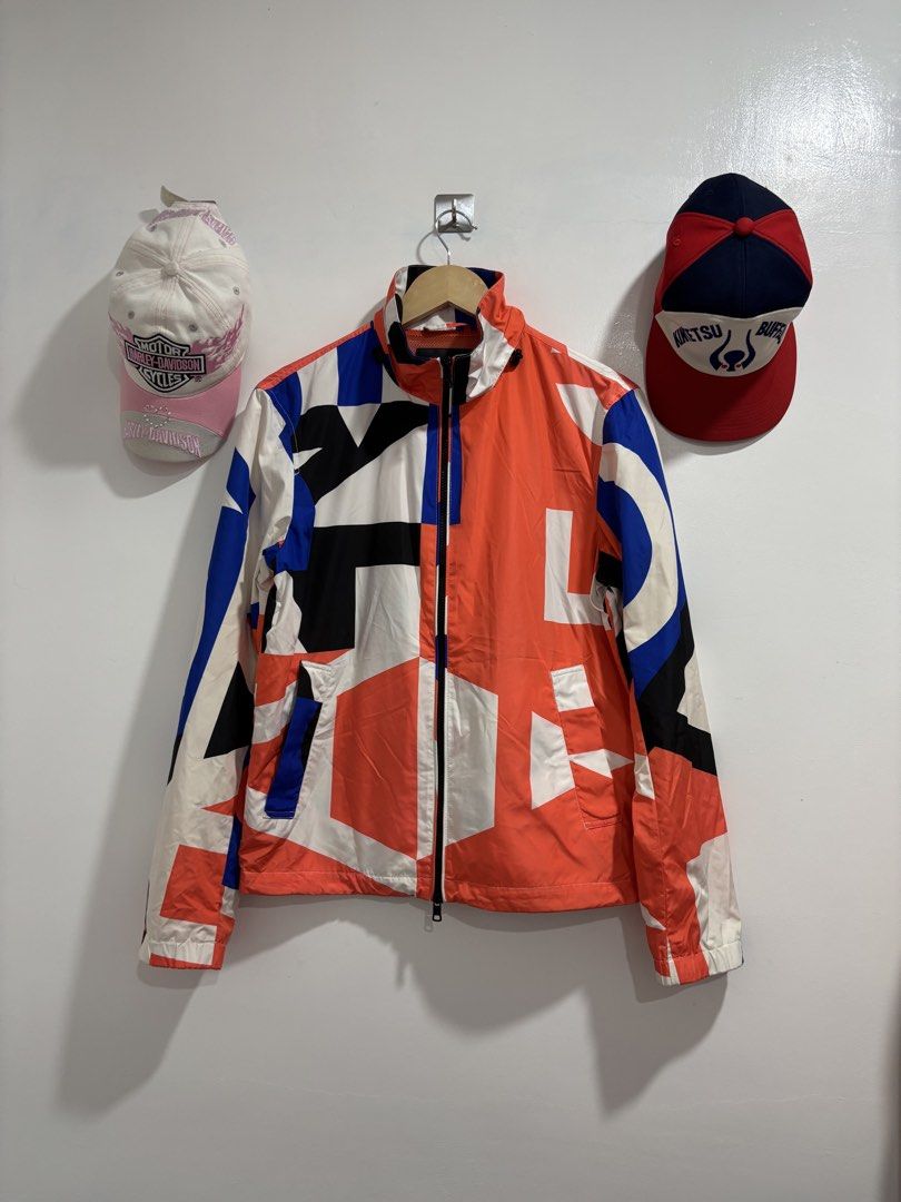 Armani Exchange Colorblock Windbreaker Jacket (Category: Coats, Jackets and Outerwear) located in Calbayog City. Submitted by zaxcheus_castillo1708 (Listing ID 1469669001, Image 1). Description: - Brand: Armani Exchange - Type: Zip-up windbreaker jacket - Size: XS - Design: Vibrant red, blue, black, and white geometric colorblock - Interior: Bright orange mesh lining - Features: High collar, full zip closure, and front utility pockets - Style: Co