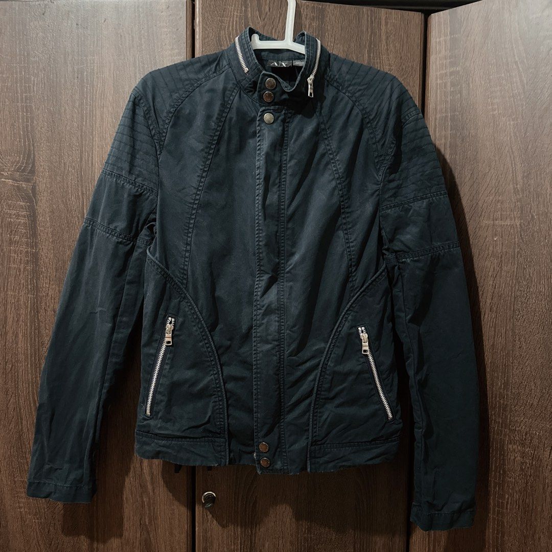 Armani Exchange Jacket Size S (Category: Coats, Jackets and Outerwear) located in Manila. Submitted by jeromepsg12 (Listing ID 1469596659, Image 1). Description: Authentic Armani Exchange dark blue jacket in Size S. Features a stylish stand collar with snap buttons, front zipper, silver hardware, and ribbed panels on the shoulders and sleeves..