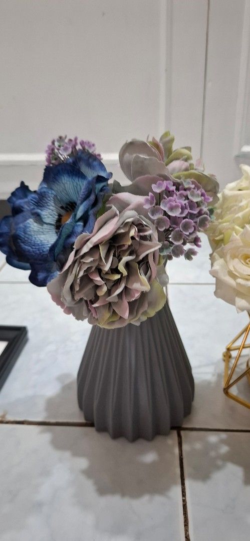 Artificial Flower Vases Set Home Decor (Category: Vases & Decorative Bowls) located in Paranaque City. Submitted by finders_thriftersph (Listing ID 1469573537, Image 2). Description: - Set of 2 ready-to-display decorative vases with artificial flowers - Left vase: Grey ribbed ceramic holding vibrant blue and purple blooms - Right vase: Geometric gold metal frame with glass cylinder holding classic white roses - Versatile centerpiece ideal for din