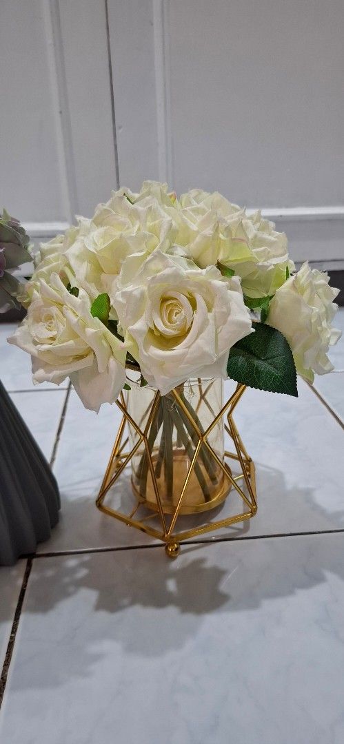 Artificial Flower Vases Set Home Decor (Category: Vases & Decorative Bowls) located in Paranaque City. Submitted by finders_thriftersph (Listing ID 1469573537, Image 3). Description: - Set of 2 ready-to-display decorative vases with artificial flowers - Left vase: Grey ribbed ceramic holding vibrant blue and purple blooms - Right vase: Geometric gold metal frame with glass cylinder holding classic white roses - Versatile centerpiece ideal for din