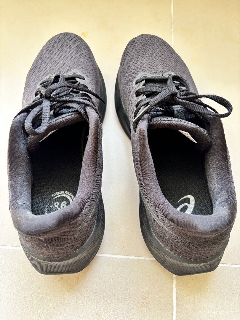 ASICS Black Running Shoes US 9.5 (Category: Casual Shoes) located in Manila. Submitted by _minimalist__ (Listing ID 1469578063, Image 3). Description: - Brand/Model: ASICS Running Shoes - Color: All Black (mesh upper, matching laces, solid rubber outsoles) - Size: US 9.5 / EUR 43.5 (Wide Fit) - Condition: Normal signs of wear on the bottom tread - Special Feature: Carbon footprint branding on inner soles.