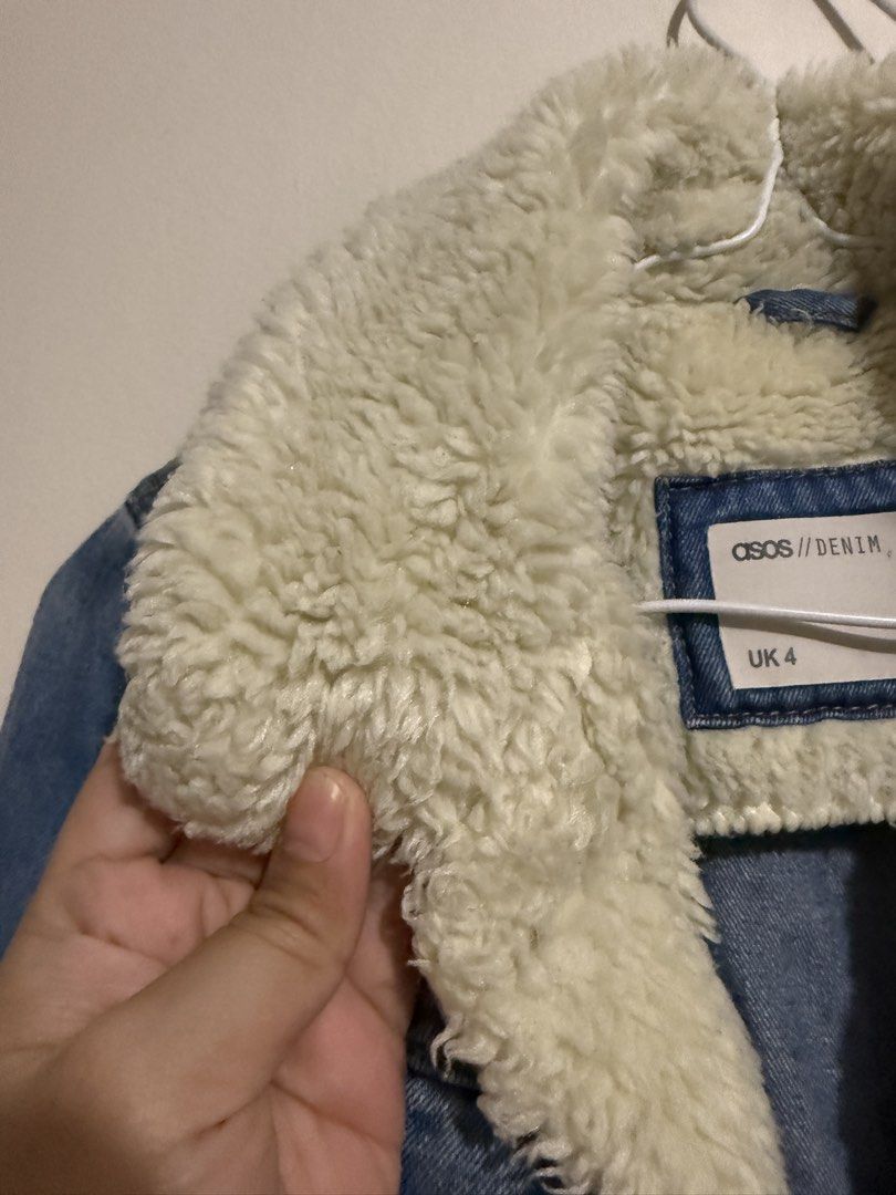 ASOS Denim Sherpa Jacket UK 4 (Category: Coats, Jackets and Outerwear) located in San Fernando. Submitted by richeloy (Listing ID 1469582268, Image 3). Description: - Brand/Style: ASOS denim jacket with classic blue wash - Lining: Warm cream sherpa collar and lining - Closure: Button-up front with durable metal buttons - Pockets: Dual chest pockets and two lower pockets - Size: UK 4 - Condition/Details: Sturdy and cozy outerwear piece, perfect fo