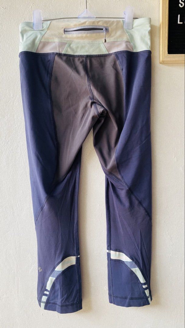 Athletic Leggings (Category: Activewear) located in Caloocan City. Submitted by lovemyclothes21 (Listing ID 1469610728, Image 3). Description: - Color: Navy blue with pastel green and purple contrast waistband - Length: Cropped (approx. 27 inches) - Storage: Secure zip pocket at the back for small essentials - Breathability: Mesh panels behind the knees - Safety: Reflective stripes near cuffs for low-light running - Fabric: Stretchy and comfortab