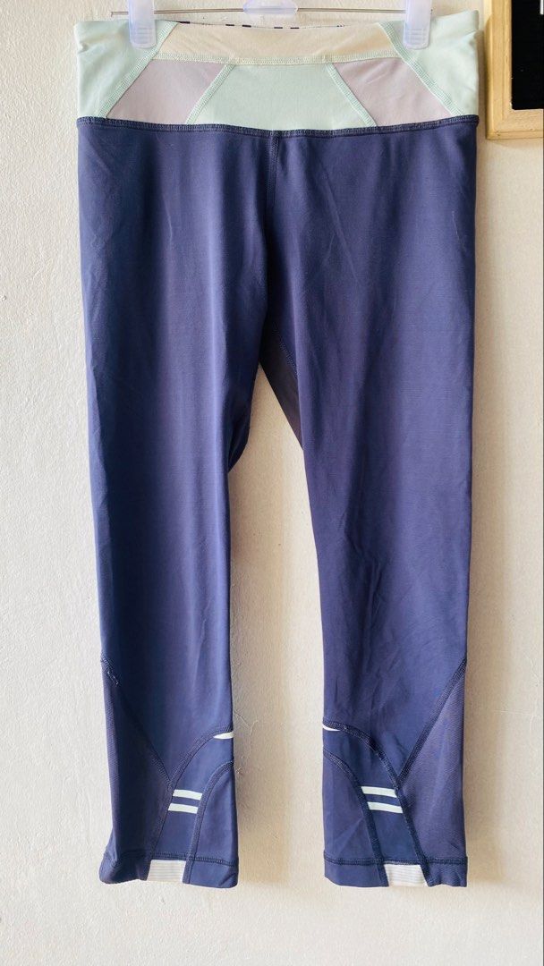 Athletic Leggings (Category: Activewear) located in Caloocan City. Submitted by lovemyclothes21 (Listing ID 1469610728, Image 2). Description: - Color: Navy blue with pastel green and purple contrast waistband - Length: Cropped (approx. 27 inches) - Storage: Secure zip pocket at the back for small essentials - Breathability: Mesh panels behind the knees - Safety: Reflective stripes near cuffs for low-light running - Fabric: Stretchy and comfortab