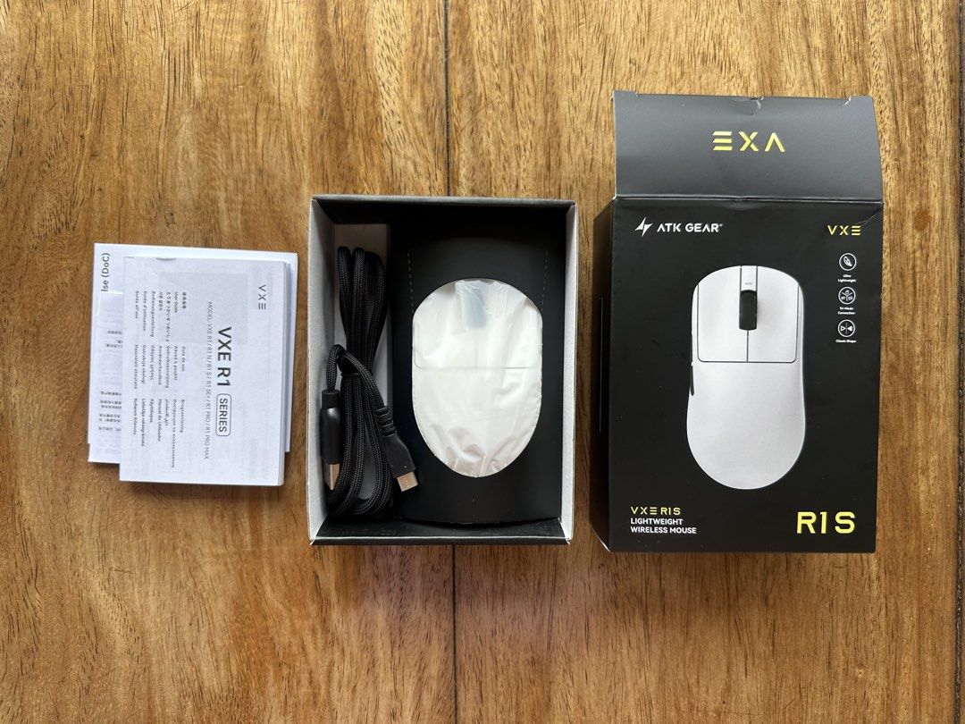 ATK Gear VXE R1 S Lightweight Wireless Mouse (Category: Mouse & Mousepads) located in Manila. Submitted by ellie.copter (Listing ID 1469602080, Image 3). Description: - Model: ATK Gear VXE R1 S Wireless Mouse - Color: White - Condition: Brand New in Box (BNIB) with protective blue films still on bottom skates - Connectivity: Tri-mode (Bluetooth, 2.4G receiver, and Wired) - Battery: 520mAh capacity for long-lasting use - Tech: Powered by Xhero AI 