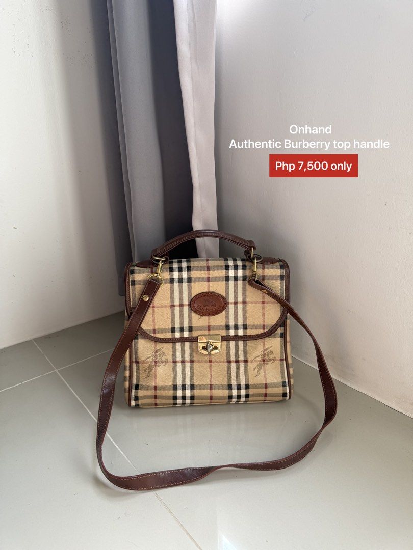 Authentic Burberry Top Handle Bag (Category: Luxury Bags & Wallets) located in Quezon City. Submitted by luxurybags.ph_official2017 (Listing ID 1469712631, Image 1). Description: - Authentic Burberry top handle bag - Iconic classic check pattern with rich brown leather trim - Elegant gold-tone hardware with secure clasp closure - Features the vintage oval Burberrys logo badge on front - Includes a convenient detachable shoulder strap - Onhand and