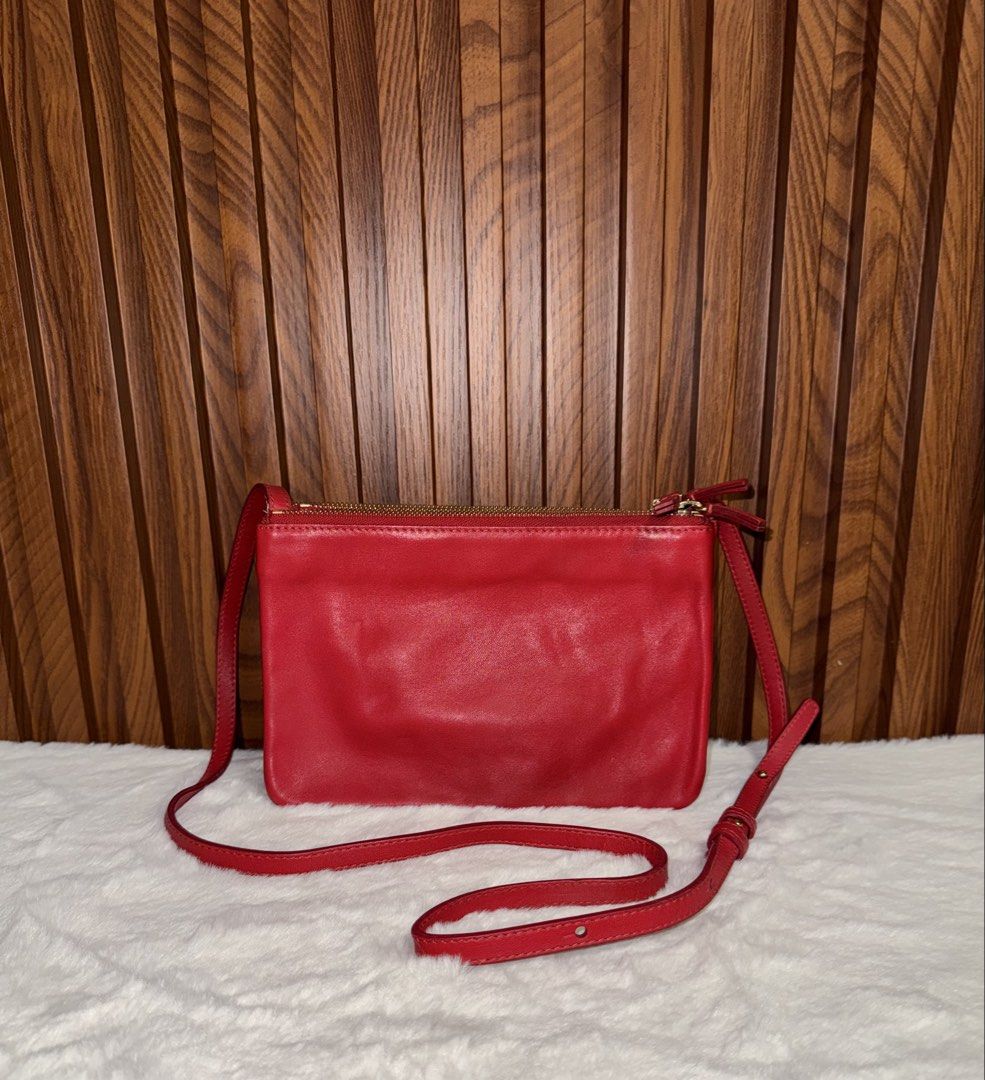 Authentic Celine Red Trio Crossbody Bag (Category: Everything Else Others) located in Subic. Submitted by luxshoppe88 (Listing ID 1469708884, Image 3). Description: - Authentic bright red Celine Trio bag - Crafted from smooth leather with clean fabric lining - Features three zippered compartments that snap together - Adjustable long thin strap with buckle closure - Elegant gold-tone hardware and front Celine logo stamp - Versatile and lightweight