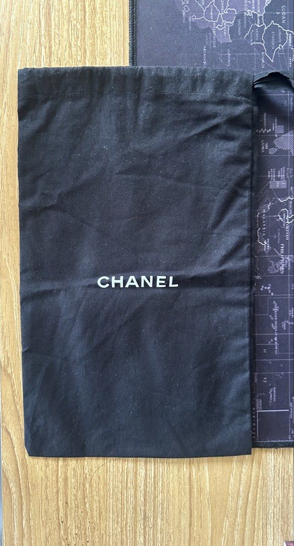 Authentic CHANEL Black Drawstring Dust Bag 34x22cm (Category: Luxury Bags & Wallets) located in Los Banos. Submitted by bianxster (Listing ID 1469576595, Image 1). Description: - Authentic Chanel dust bag - Color: Classic black with white front logo - Material: Clean, high-quality cotton - Closure: Secure top drawstring - Size: Approximately 34cm x 22cm - Condition: Excellent, clean, no stains or damage.