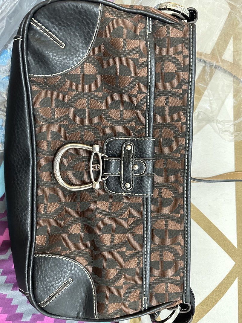 Authentic Giani Bernini Monogram Shoulder Bag (Category: Shoulder Bags) located in Manila. Submitted by emily.santiago (Listing ID 1469638525, Image 2). Description: Brand: Giani Bernini Color: Dark Brown / Espresso Monogram Jacquard Hardware: Silver-tone O-ring strap hardware & zipper pull Features: Zip-top closure for safe storage Clean black inner lining with interior zipper pocket and round Giani Bernini crest patch Comfortable shoulder strap