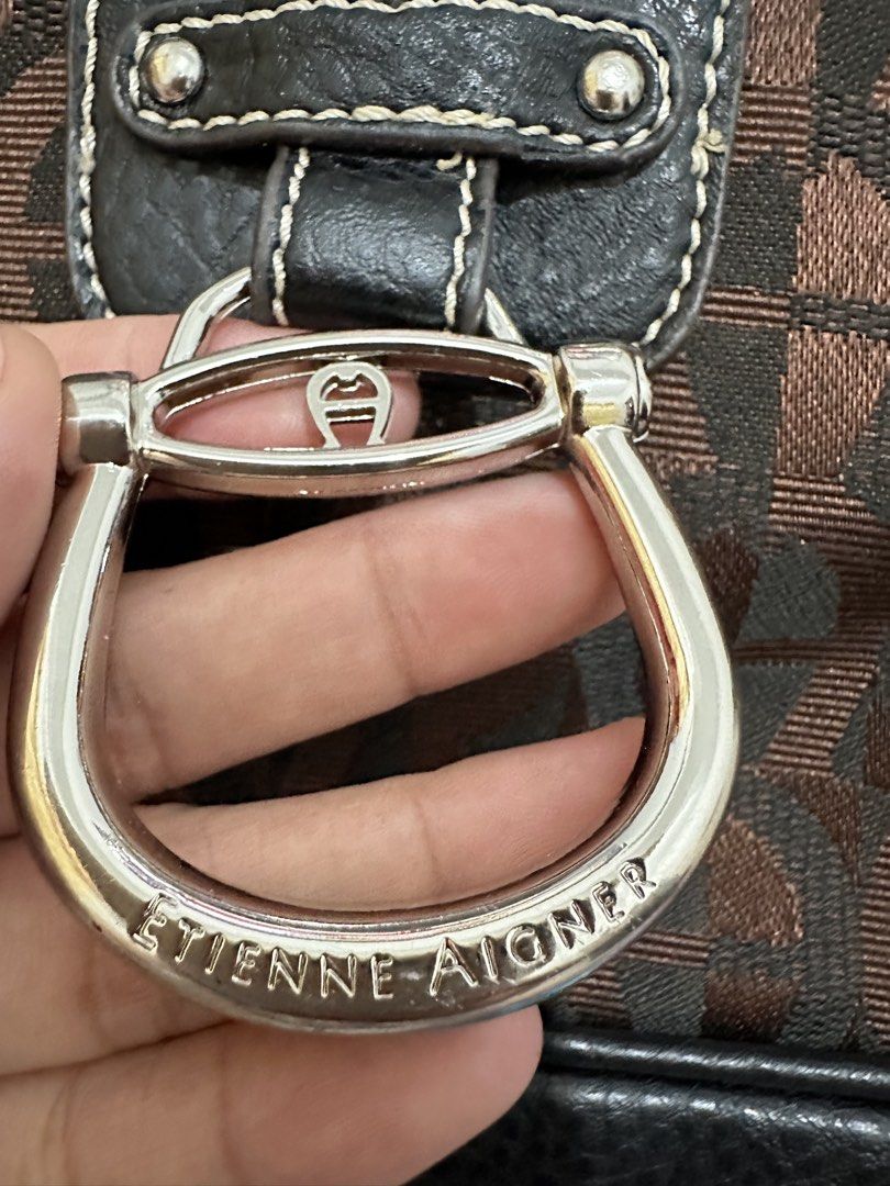 Authentic Giani Bernini Monogram Shoulder Bag (Category: Shoulder Bags) located in Manila. Submitted by emily.santiago (Listing ID 1469638525, Image 3). Description: Brand: Giani Bernini Color: Dark Brown / Espresso Monogram Jacquard Hardware: Silver-tone O-ring strap hardware & zipper pull Features: Zip-top closure for safe storage Clean black inner lining with interior zipper pocket and round Giani Bernini crest patch Comfortable shoulder strap
