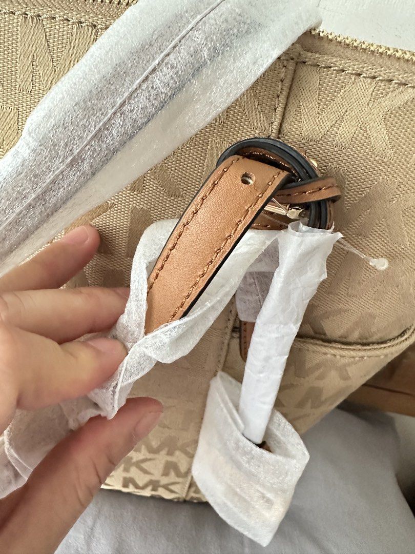 Authentic MK Charlotte Tote Bag - Beige / Tan (Category: Shoulder Bags) located in Manila. Submitted by emily.santiago (Listing ID 1469623291, Image 2). Description: Authentic Michael Kors Charlotte Large Zip Top Tote Bag (Vanilla / Beige) - BRAND NEW ✨ Condition: BRAND NEW & NEVER USED! 💯 (Protective wrappers are still intact on straps and charm as seen in photos! Price slightly negotiable.