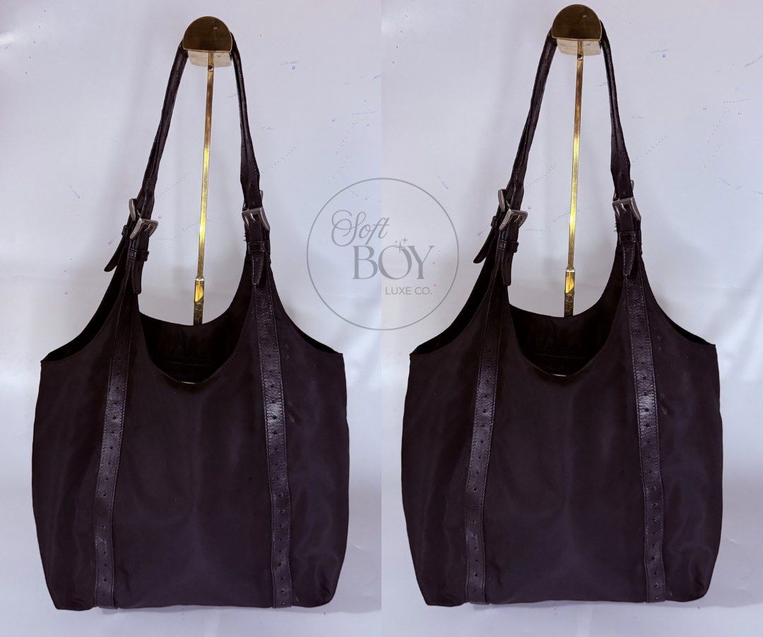 Authentic Prada Vintage Hobo / Shoulder Bag – Black (Category: Luxury Bags & Wallets) located in Manila. Submitted by raymondabigan (Listing ID 1469662807, Image 2). Description: Authentic Prada Vintage Hobo / Shoulder Bag – Black A vintage Prada nylon shoulder bag featuring the iconic triangular Prada Milano logo plaque, leather trim, and adjustable leather shoulder straps with buckle details. Its relaxed hobo silhouette and spacious interior ma