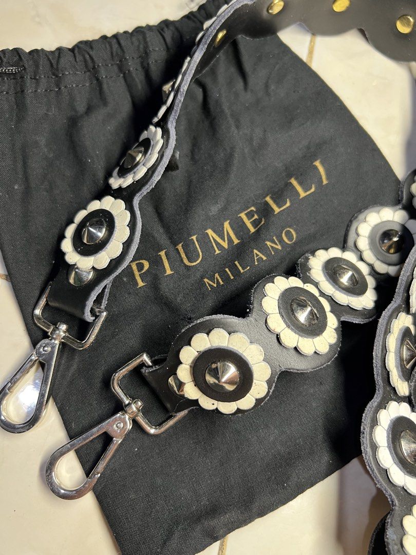 AUTHENTIC PUIMELLI Bag Strap (Category: Luxury Bags & Wallets) located in General Santos City (Dadiangas). Submitted by queenfinds (Listing ID 1469719763, Image 3). Description: Piumelli Milano black leather floral bag strap with white flower appliqués and silver-tone hardware. Issue ->>> leather Loc. General Santos City.
